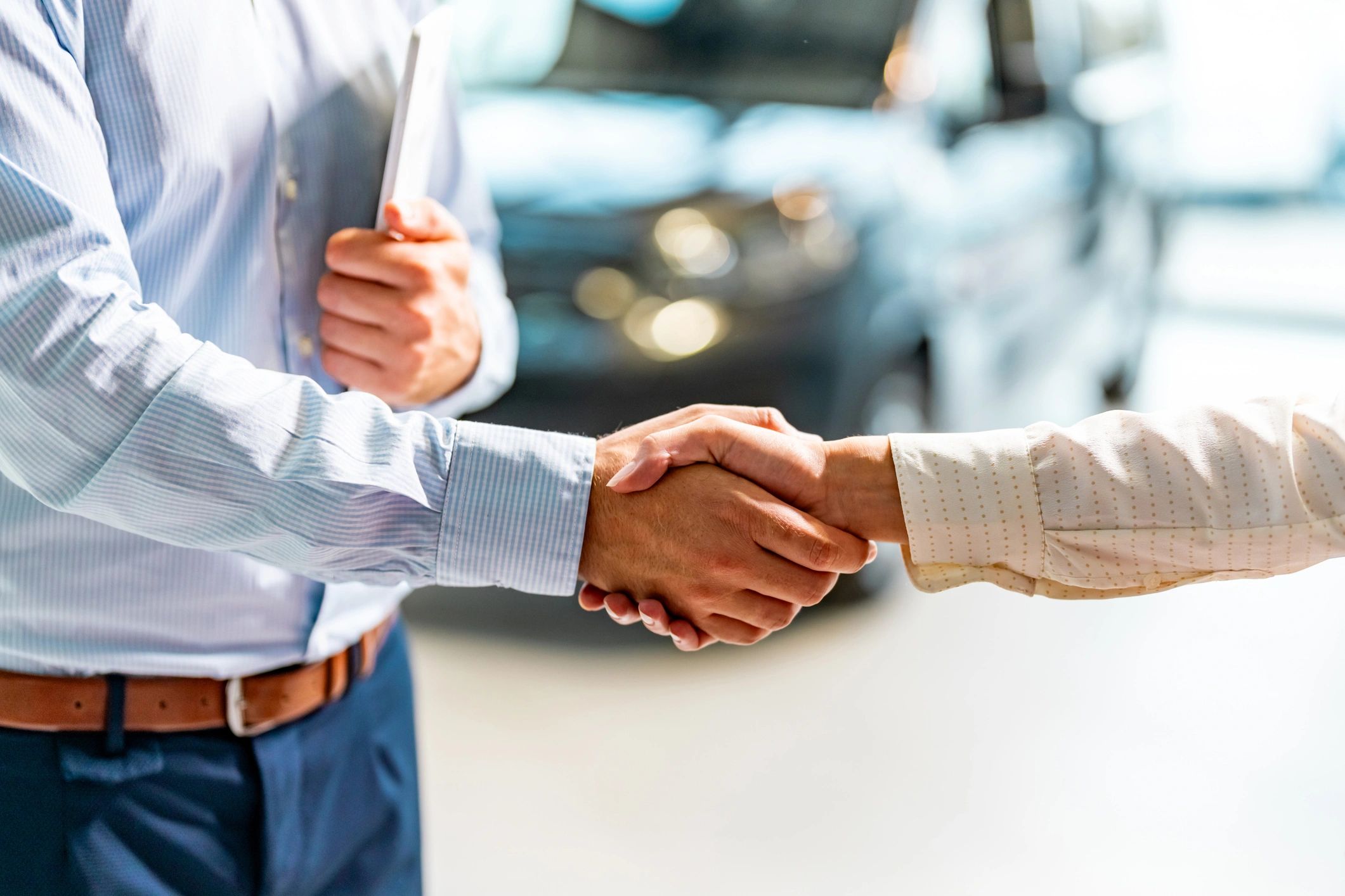 Dealership representative greeting a customer