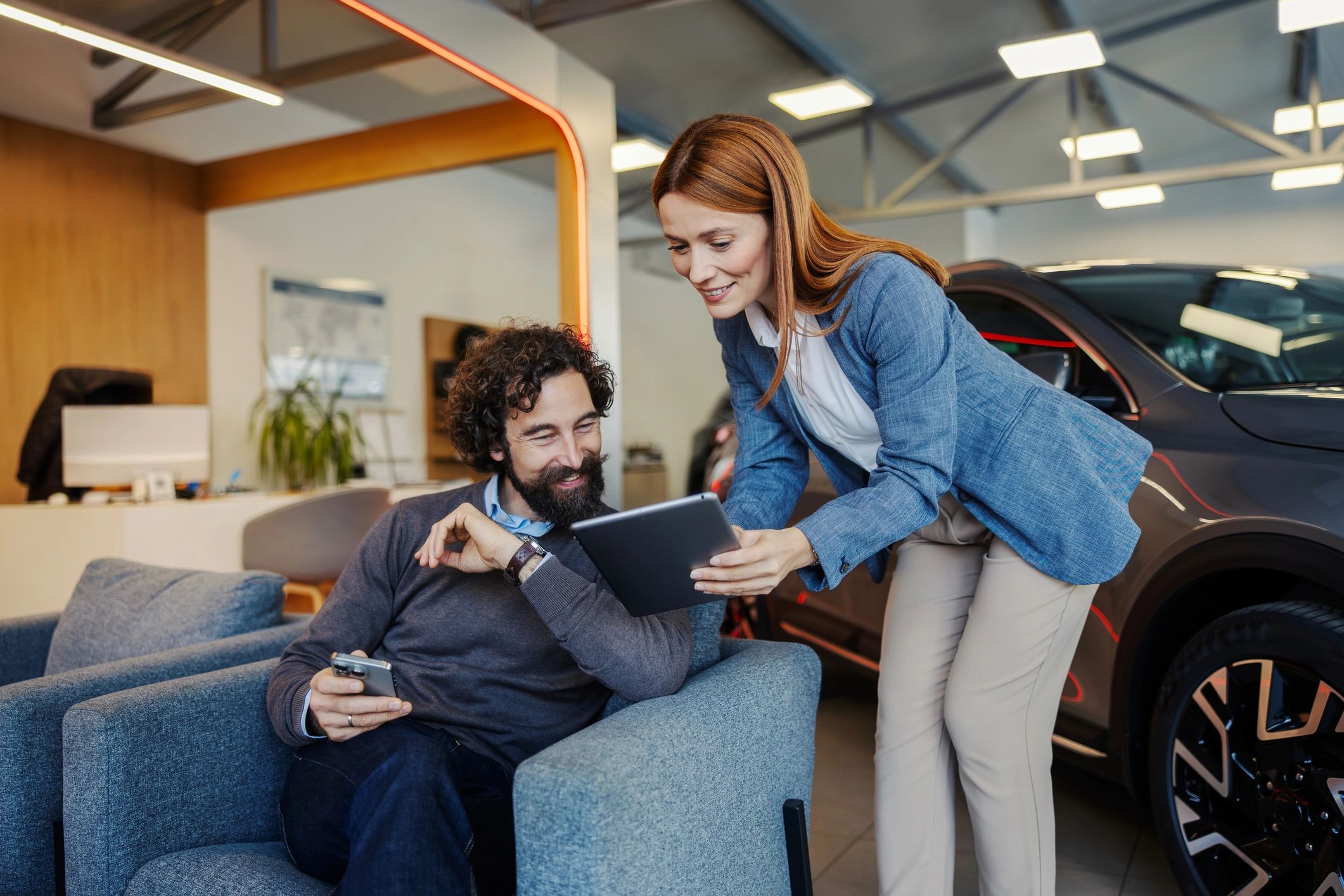 Customer speaking with a dealership representative in a modern showroom